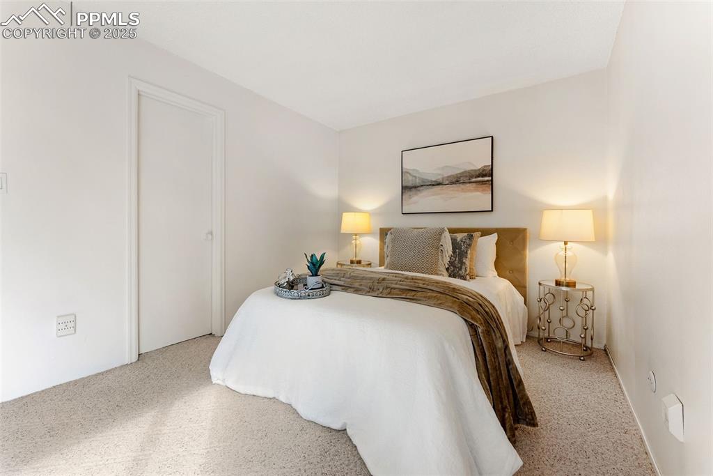 Image 14 of 30: Large primary bedroom with double closets, sitting/dressing area and an ens