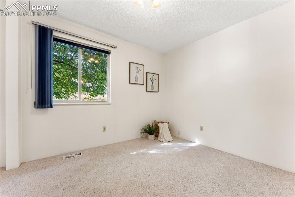 Image 18 of 30: Second bedroom across the hall from the bathroom