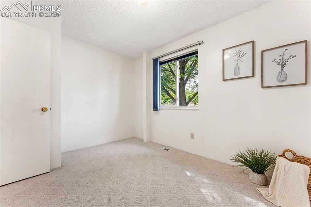 Image 19 of 30: Second bedroom across the hall from the bathroom