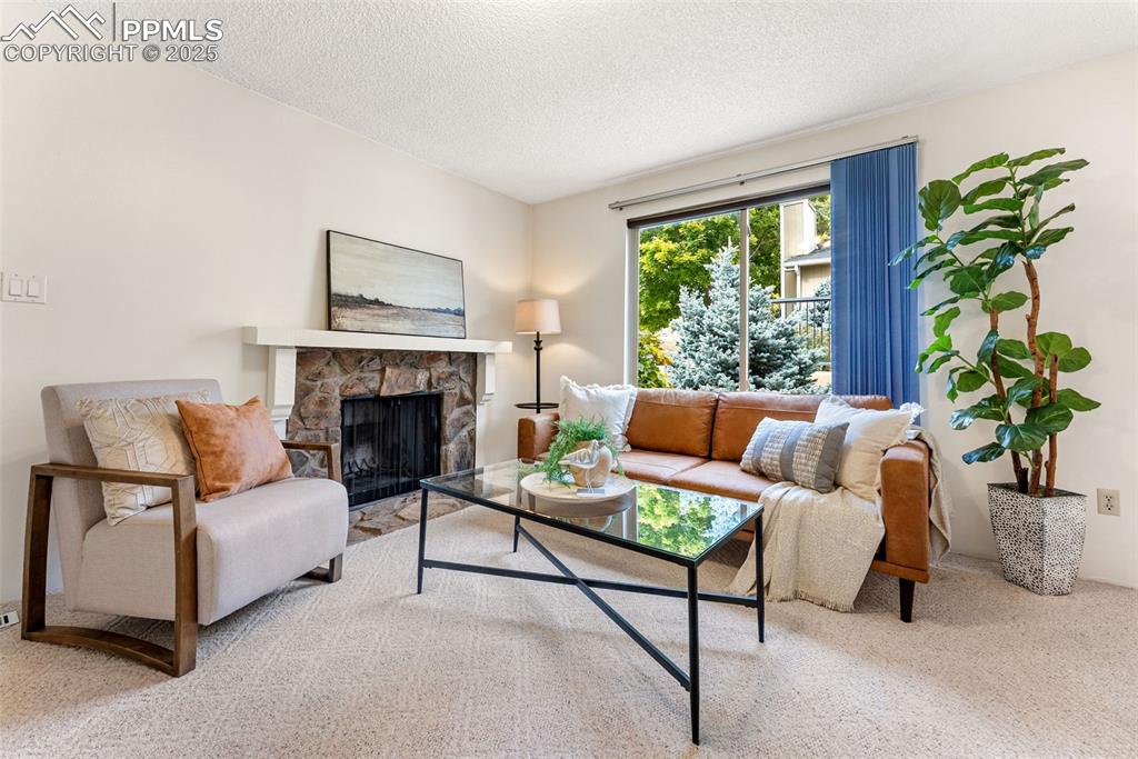 Image 2 of 30: Spacious living room with a wood burning fireplace