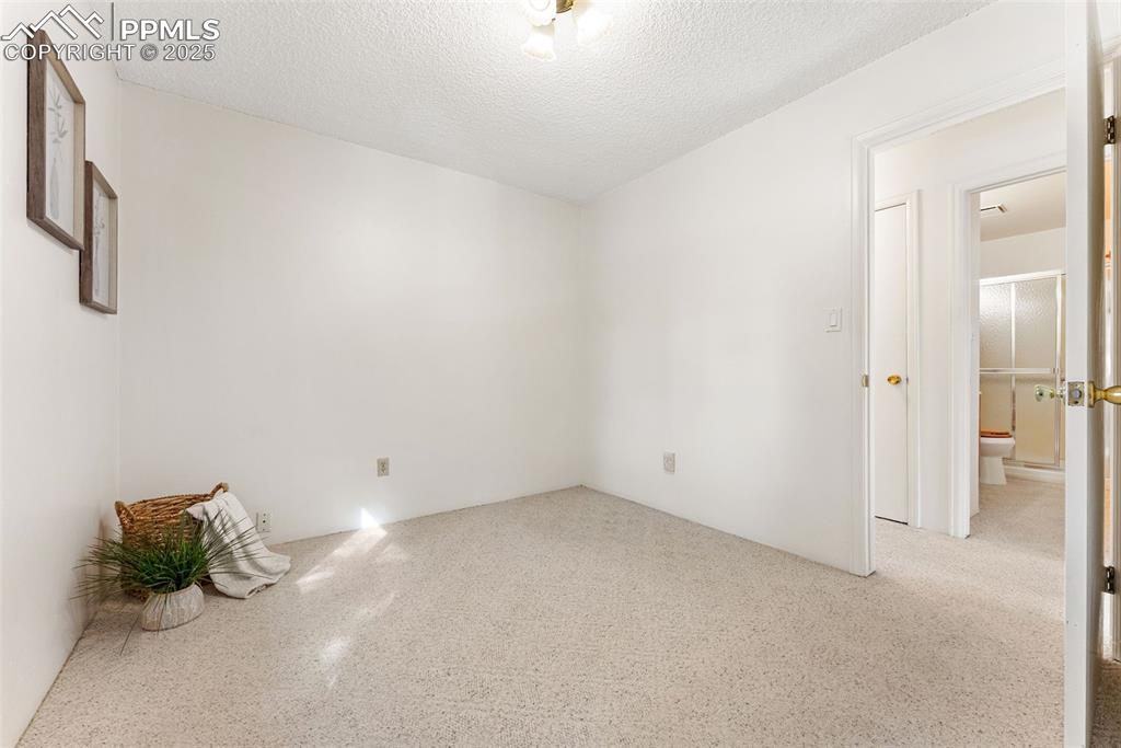 Image 20 of 30: Second bedroom across the hall from the bathroom
