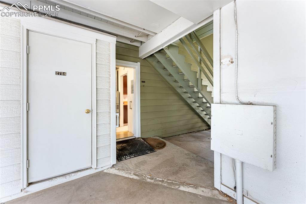 Image 27 of 30: Covered parking attached to the unit with a convenient storage room