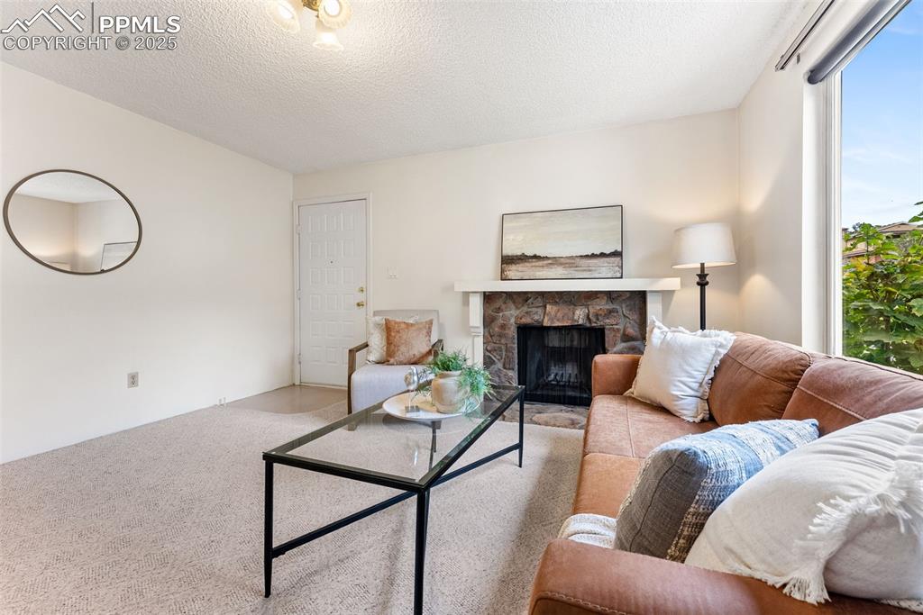 Image 3 of 30: Spacious living room with a wood burning fireplace