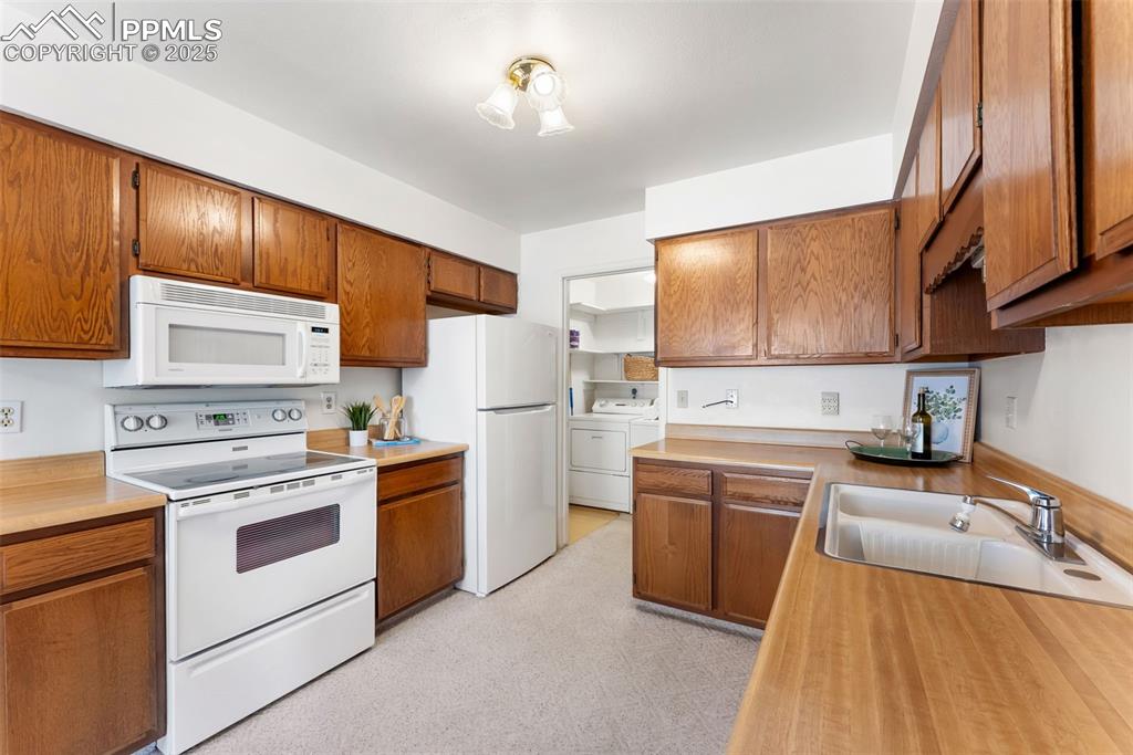 Image 7 of 30: Full kitchen with plenty of counter and cabinet space