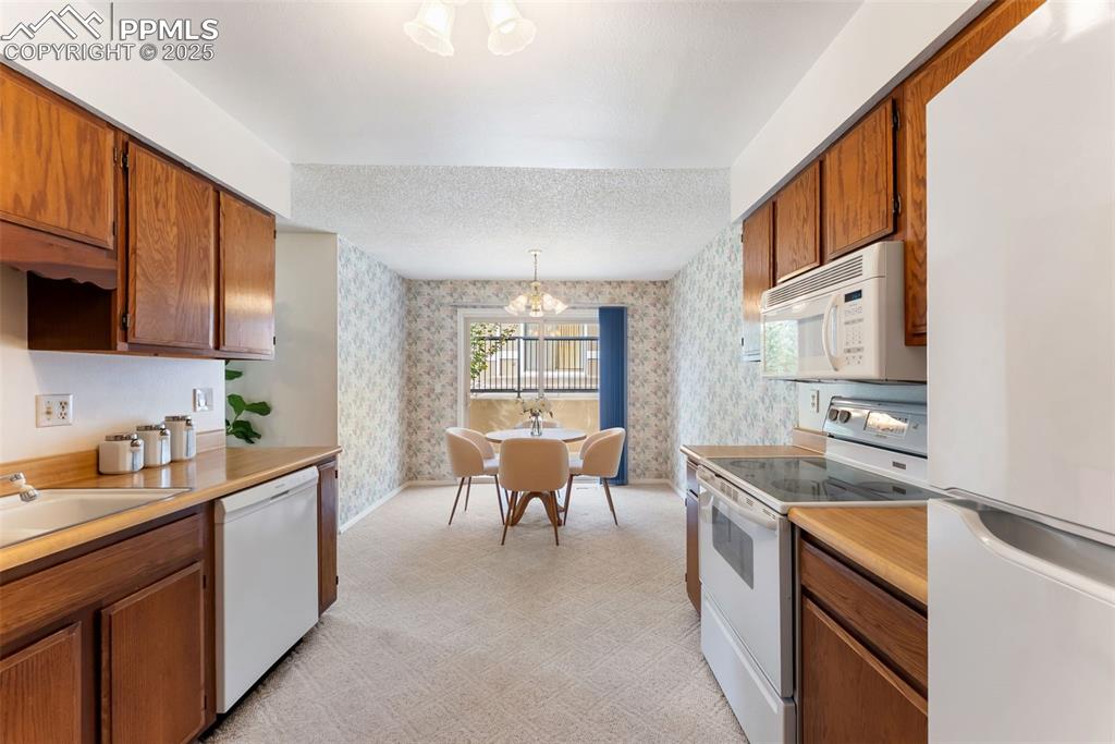 Image 9 of 30: Dining room right off the kitchen with a walkout to the back patio