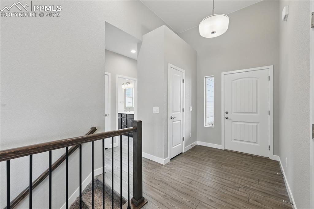 Image 10 of 35: Entrance foyer featuring wood finished floors, a healthy amount of sunlight