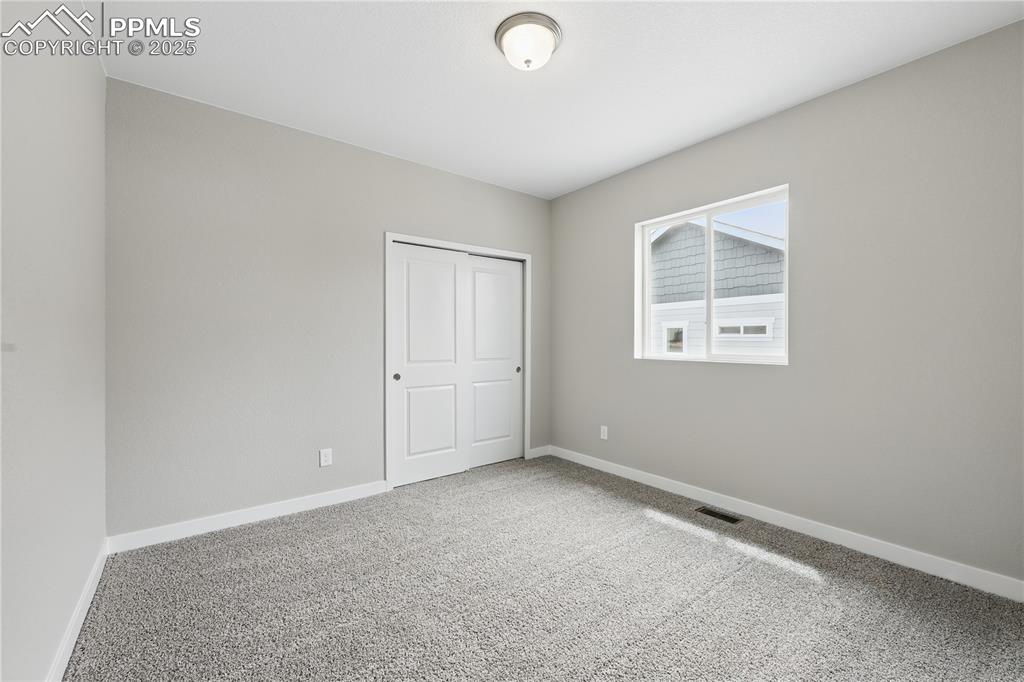 Image 11 of 35: Carpeted spare room with visible vents and baseboards