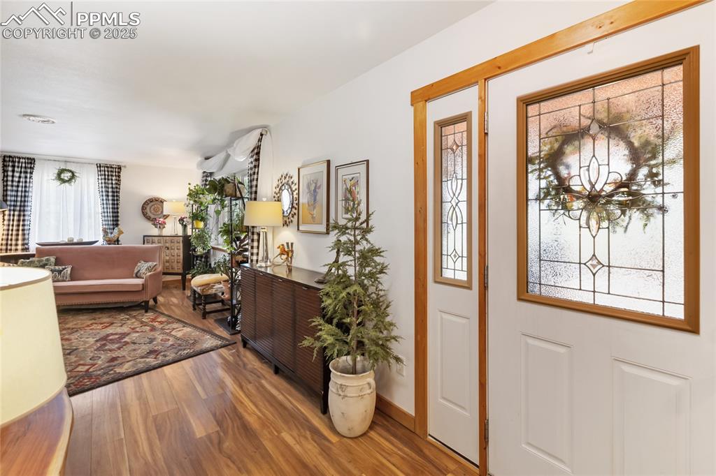 Image 19 of 50: Entryway with wood finished floors