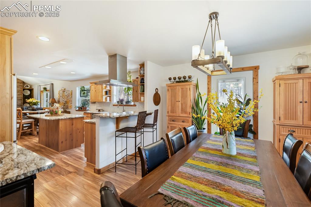 Image 25 of 50: Dining space featuring healthy amount of natural light, light wood-type flo
