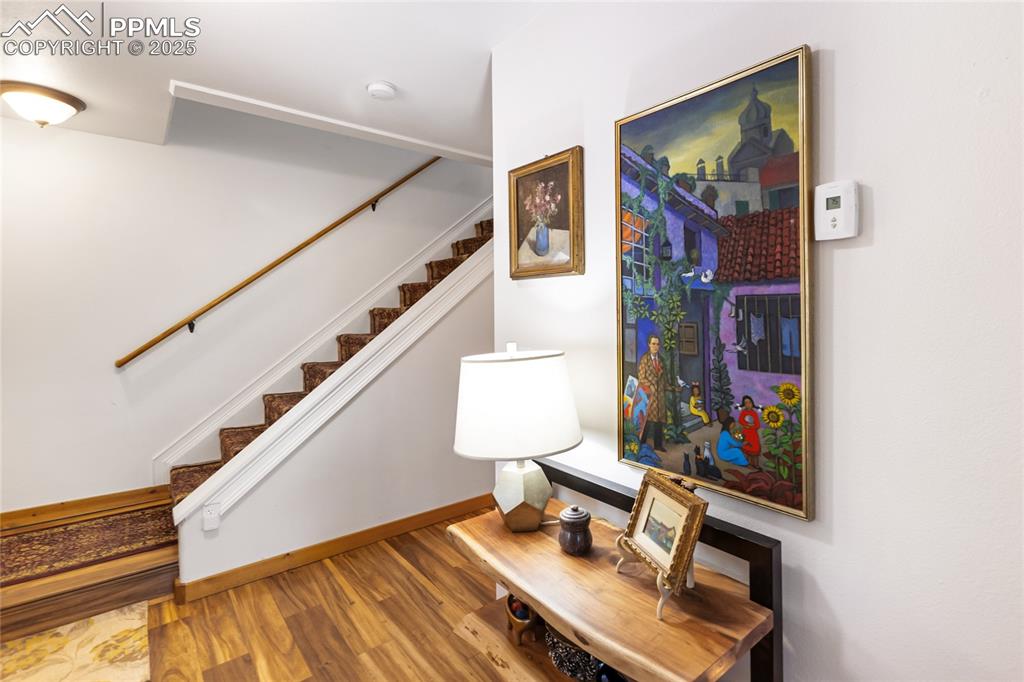 Image 38 of 50: Stairs featuring wood finished floors and baseboards