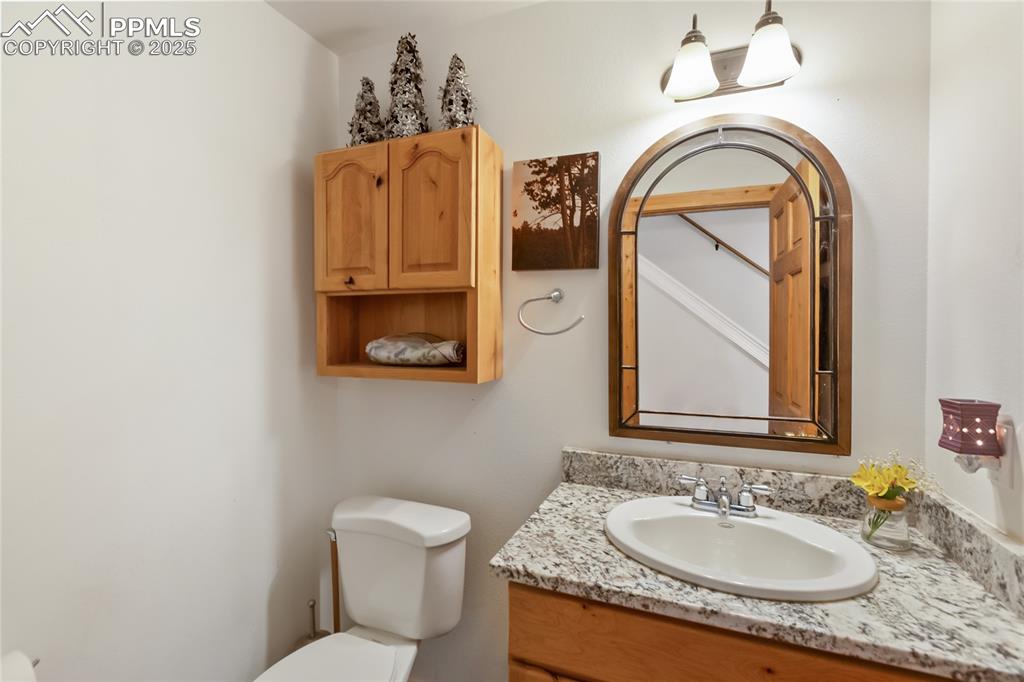 Image 39 of 50: Half bathroom with toilet and vanity