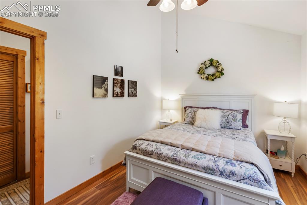 Image 41 of 50: Bedroom with wood finished floors and ceiling fan
