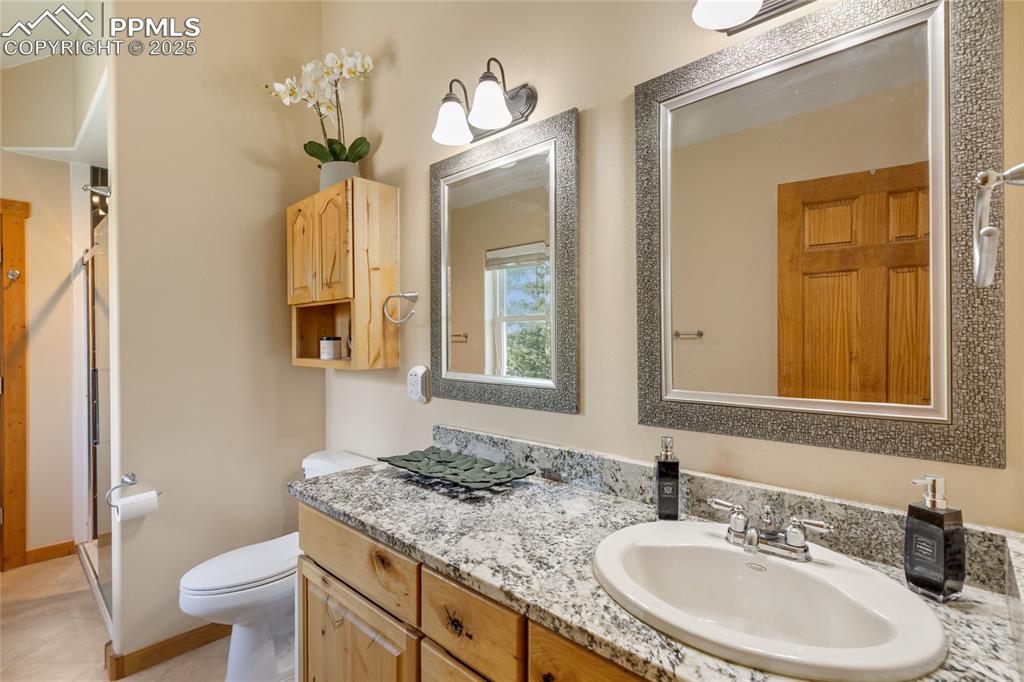 Image 46 of 50: Bathroom with a stall shower, vanity, and tile patterned flooring