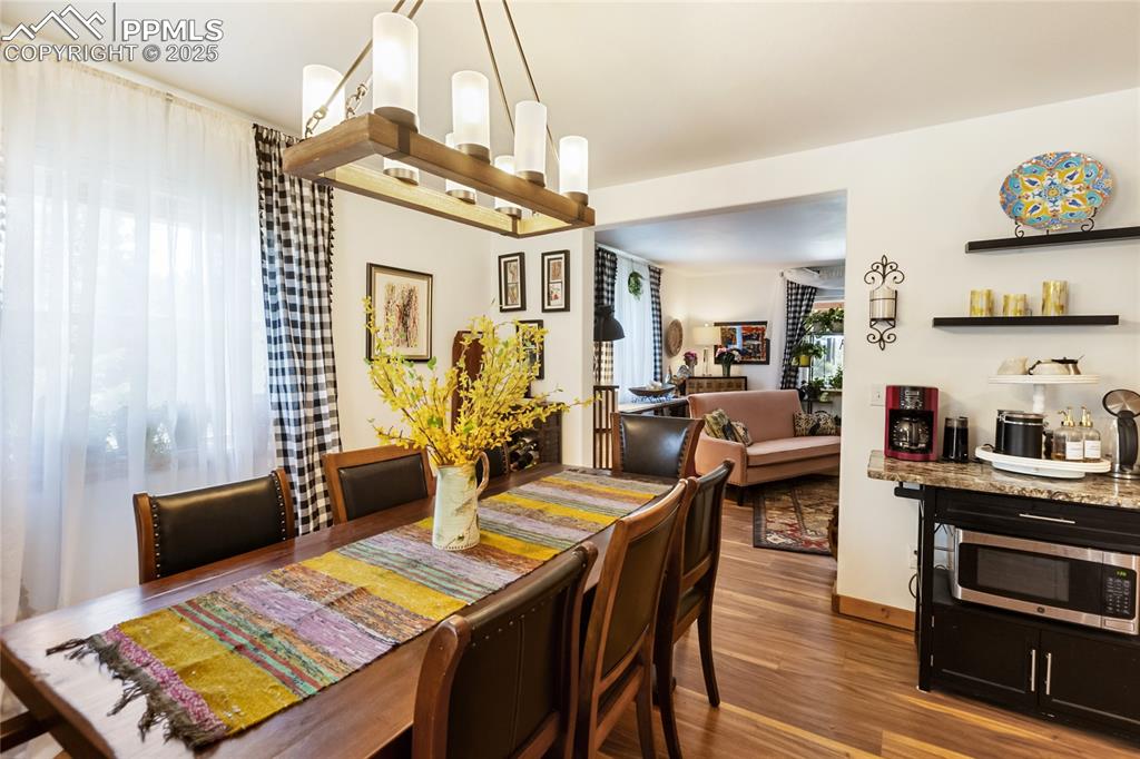 Image 5 of 50: Dining area with wood finished floors and baseboards