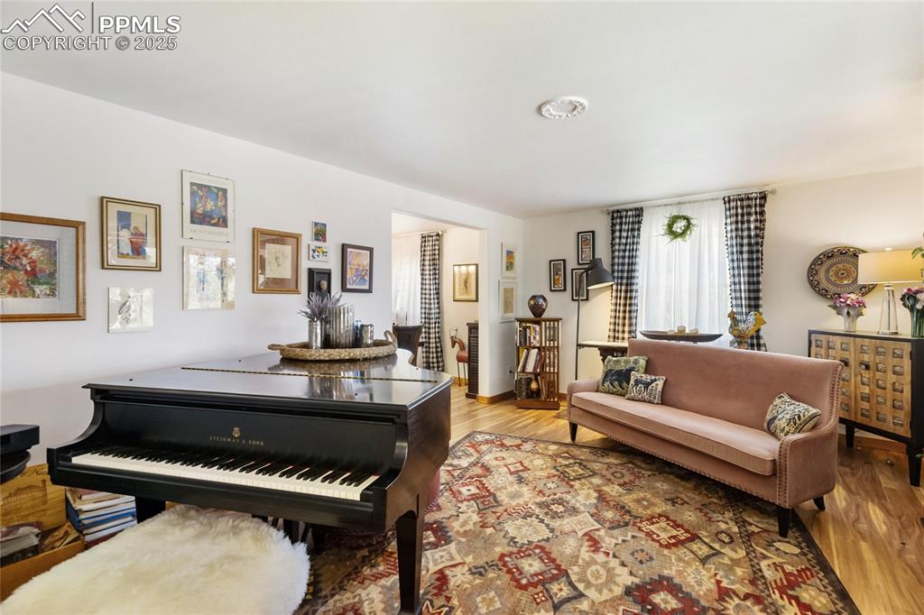 Image 7 of 50: Additional family room featuring light wood-type flooring