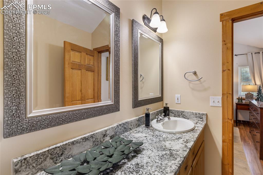 Image 9 of 50: Bathroom featuring wood finished floors and vanity