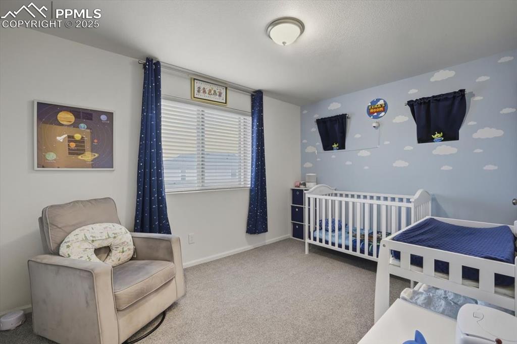 Image 13 of 35: Upper level 1st bedroom.