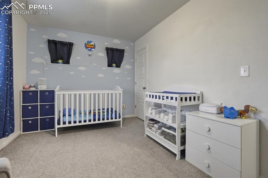 Image 14 of 35: Upper level 1st bedroom.