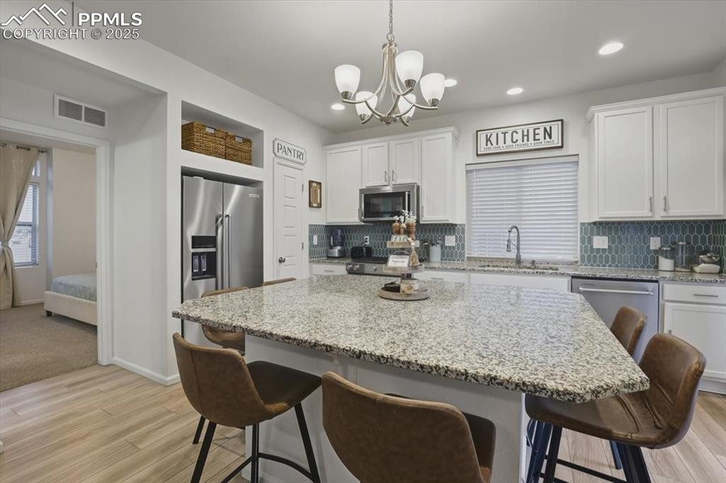 Image 24 of 35: Large granite island.