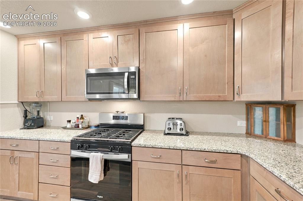 Image 6 of 50: Soft pull cool Dusk stain cabinets with upgraded hardware.