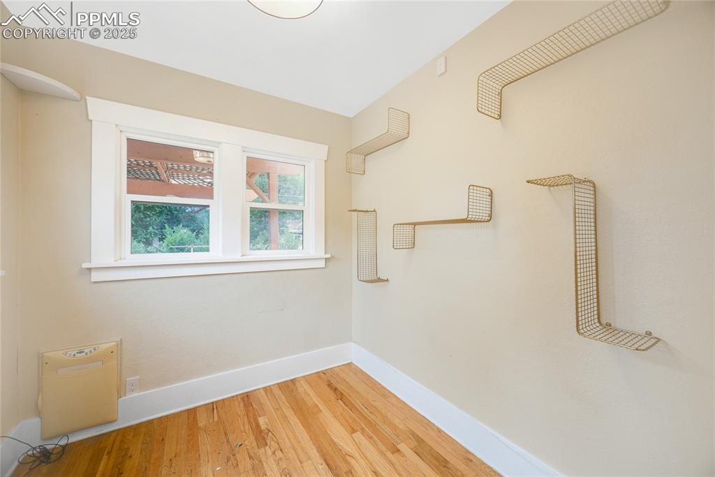 Image 13 of 28: Empty room with baseboards and hardwood / wood-style floors