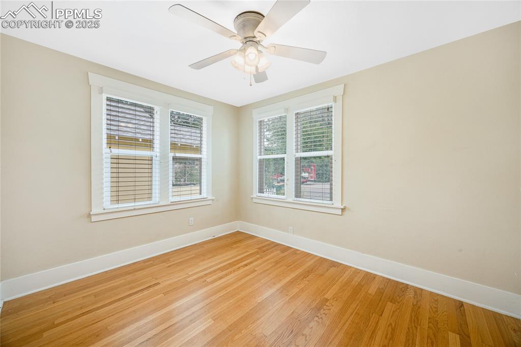 Image 15 of 28: Unfurnished room featuring wood finished floors and baseboards