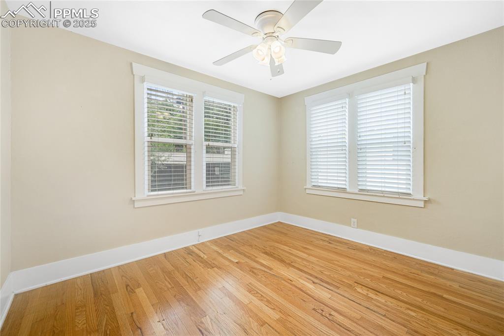 Image 18 of 28: Empty room featuring wood-type flooring and baseboards