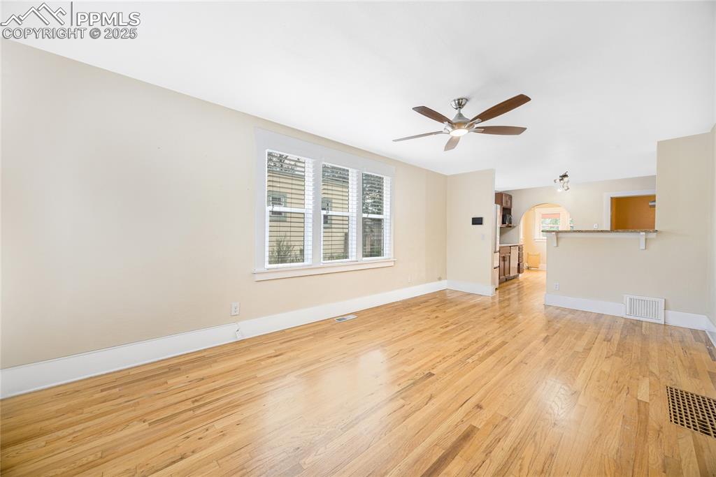 Image 5 of 28: Unfurnished living room featuring light wood-style flooring, a ceiling fan,