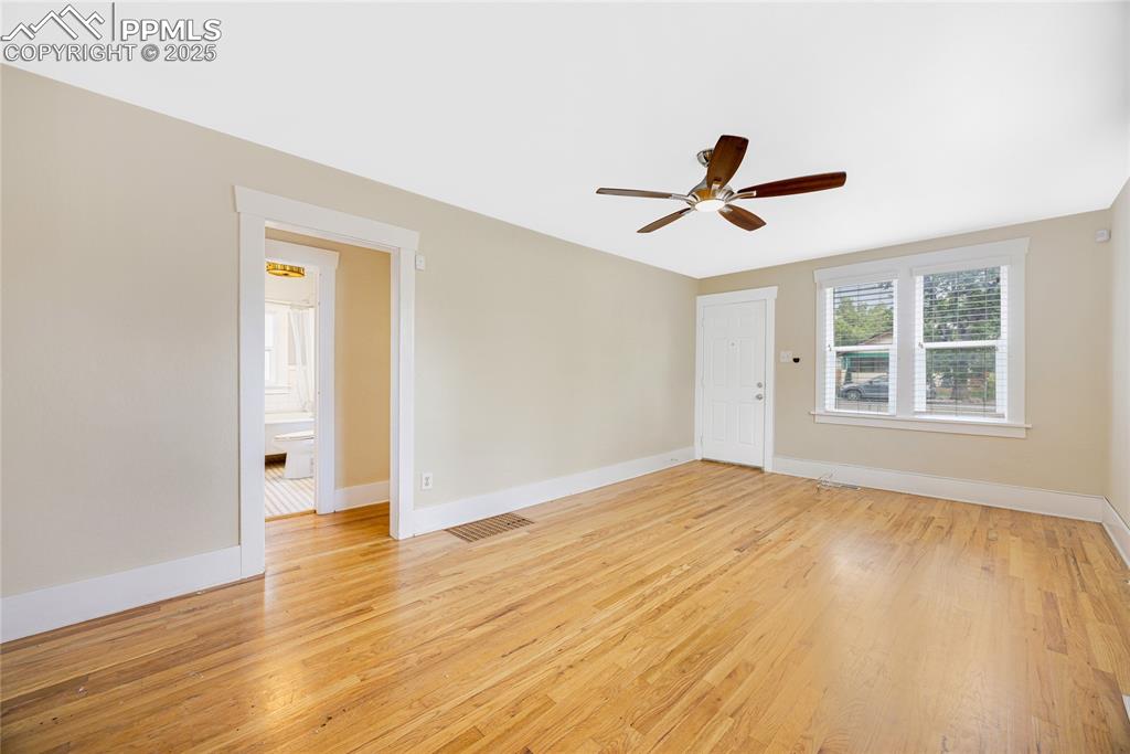 Image 7 of 28: Empty room featuring light wood-style flooring and a ceiling fan