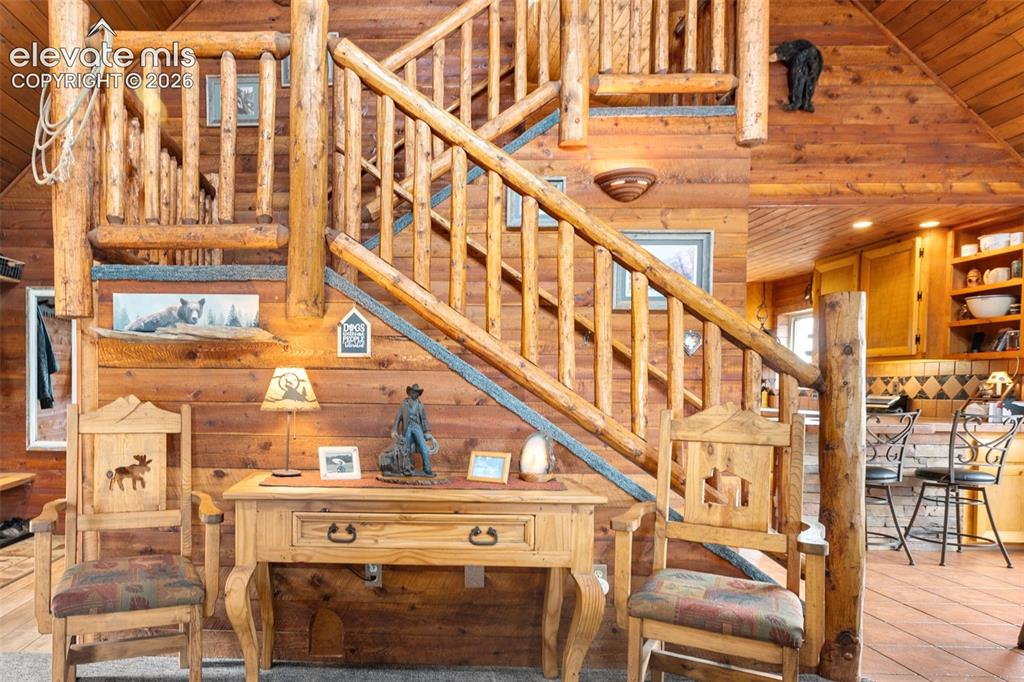 Image 6 of 44: Gorgeous Living Room With Vaulted Ceilings and log staircase. 