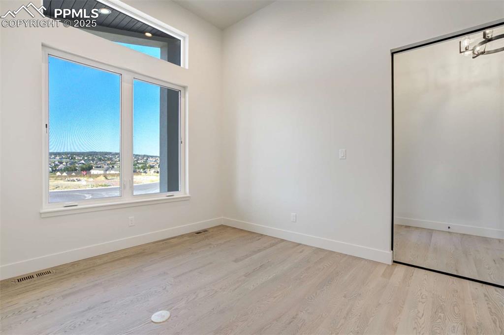 Image 13 of 34: Spare room featuring baseboards and light wood finished floors