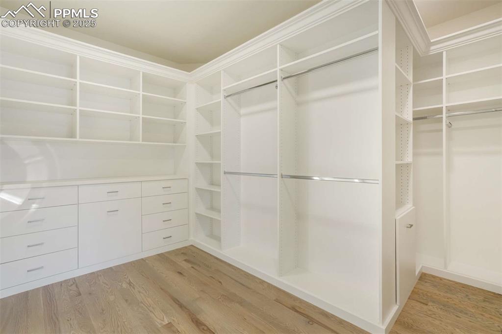 Image 17 of 34: Spacious closet with light wood finished floors