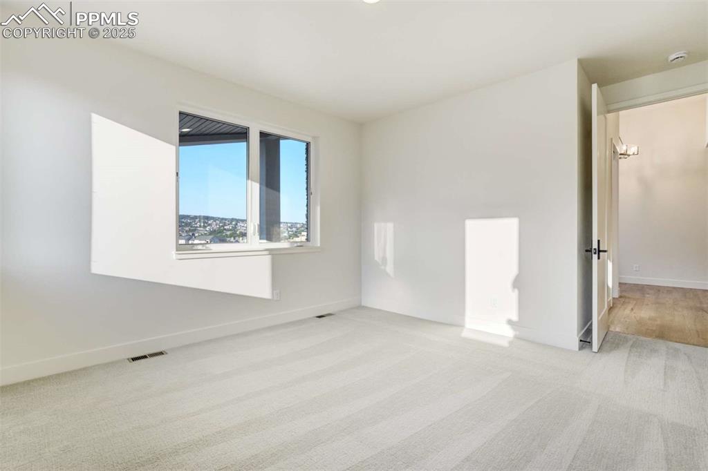 Image 18 of 34: Unfurnished room featuring light carpet and baseboards