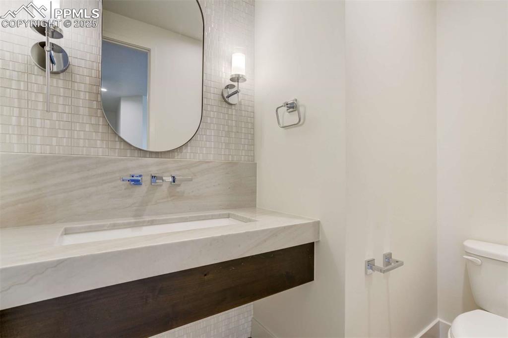 Image 20 of 34: Bathroom featuring vanity and backsplash