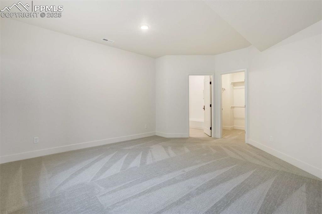 Image 24 of 34: Empty room featuring light colored carpet and recessed lighting