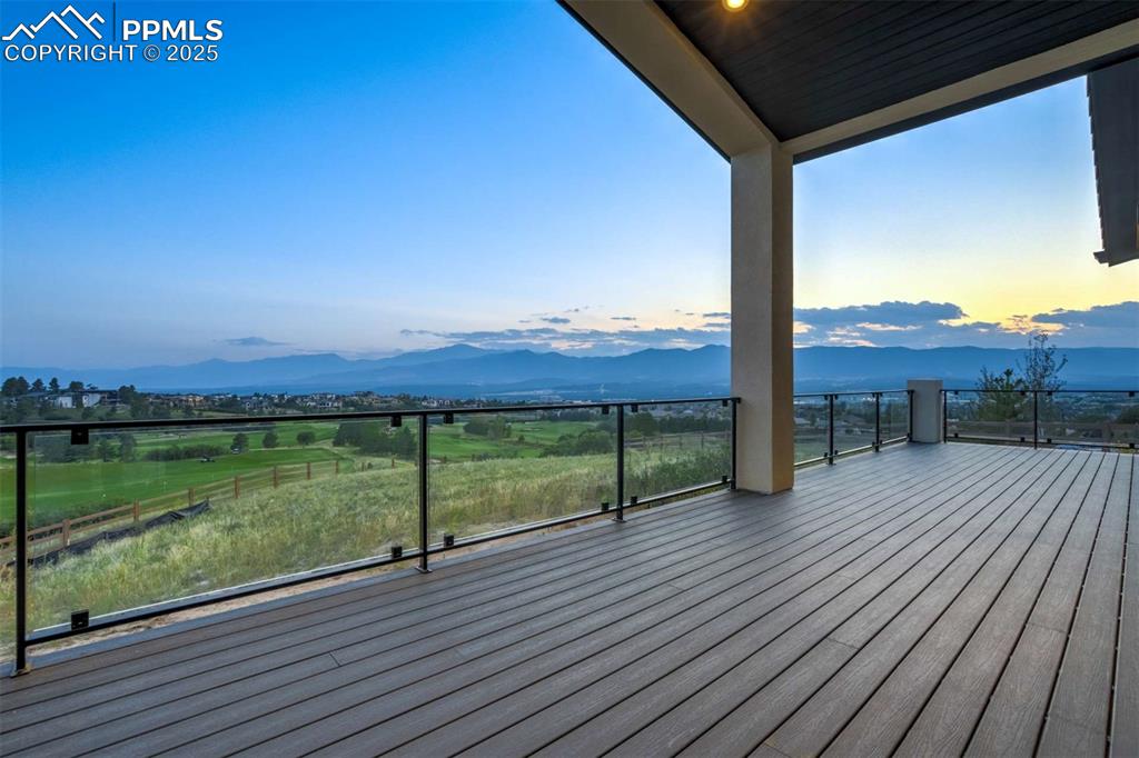 Image 34 of 34: Wooden terrace featuring a patio area and a mountain view