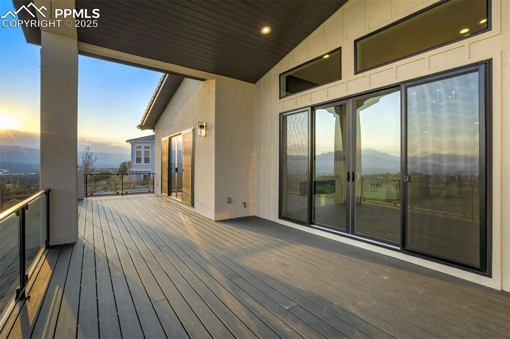 Image 38 of 40: Deck at dusk with a mountain view and a patio area