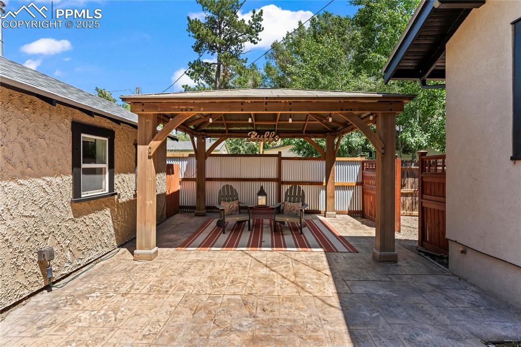 Image 2 of 42: Covered patio between house and garage.