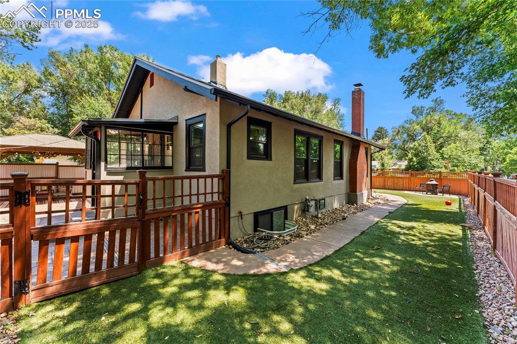 Image 37 of 42: Fully turfed yard with fire pit and 2 dog runs