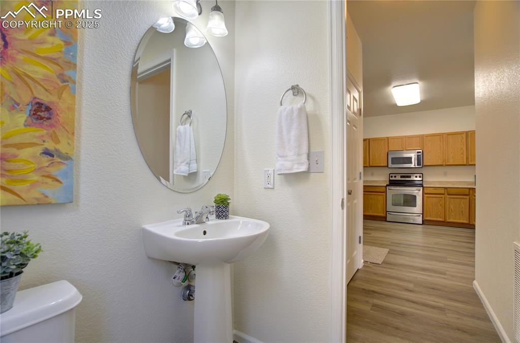 Image 12 of 38: half bathroom off of kitchen on main level