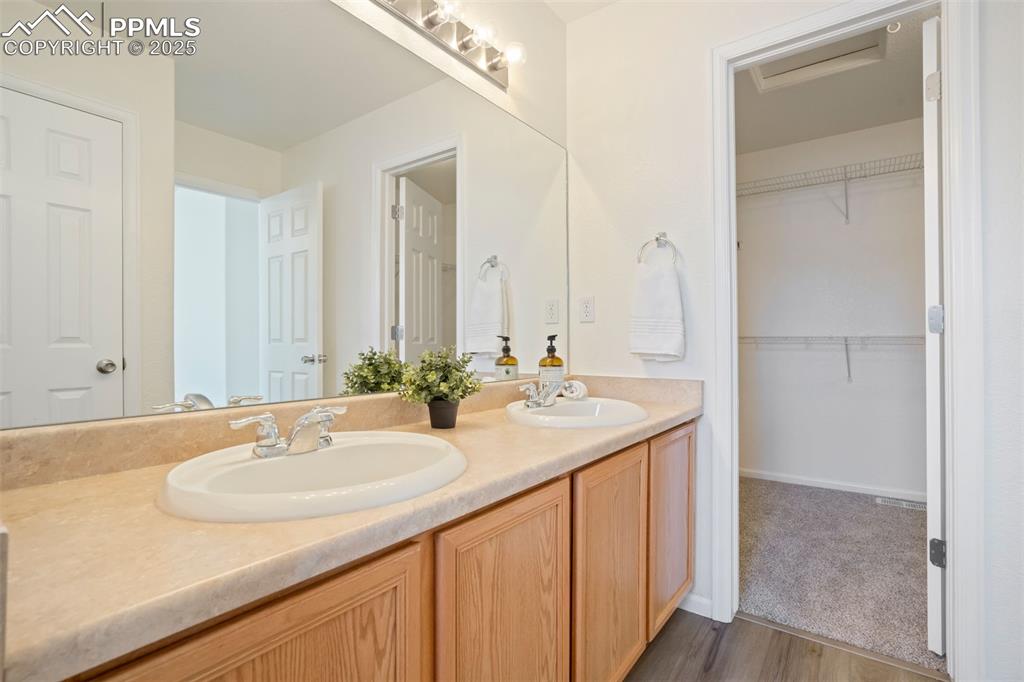 Image 20 of 38: walk-in closet attached to primary bathroom