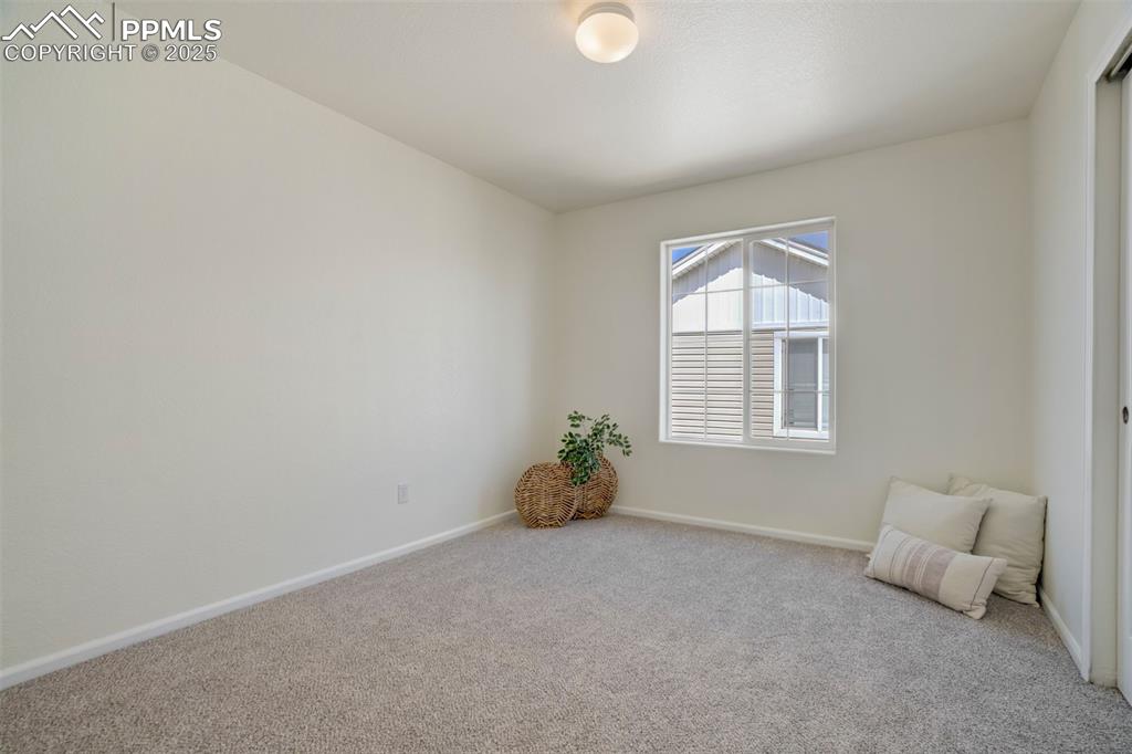 Image 24 of 38: A third bedroom on the upper level