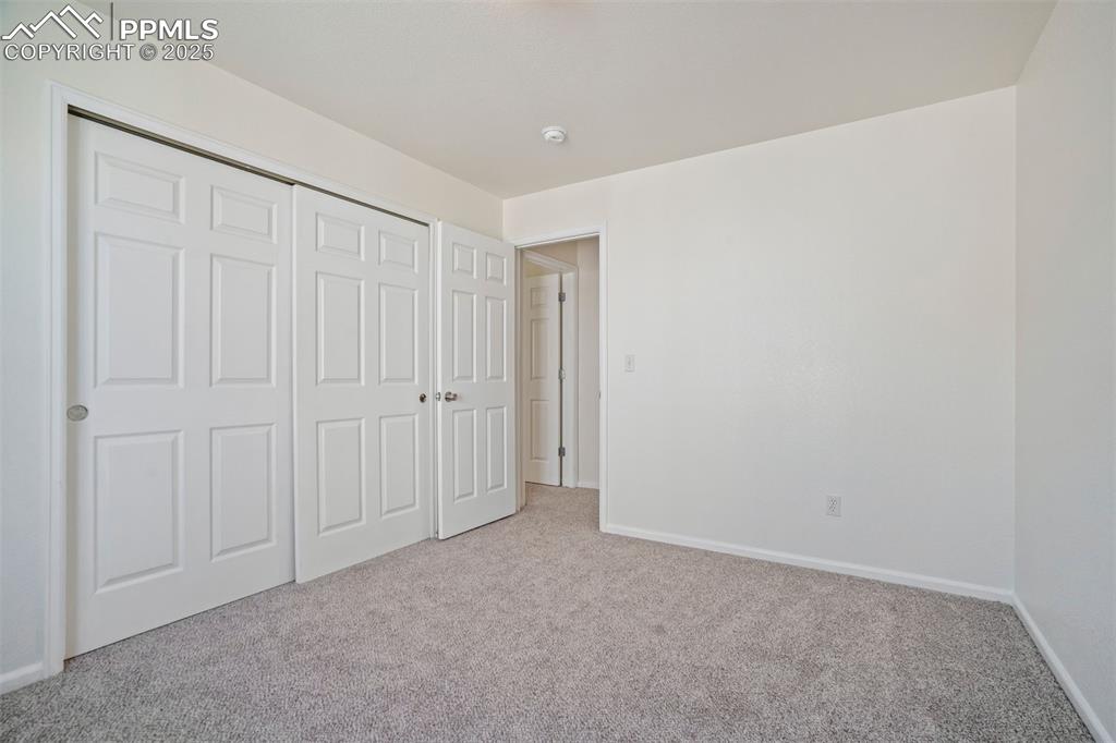 Image 25 of 38: Third bedroom on upper level