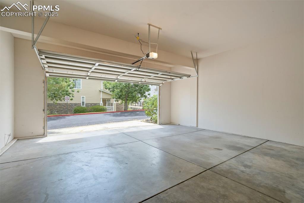 Image 29 of 38: Large 2 car attached garage with extra space for workbench/hobbies