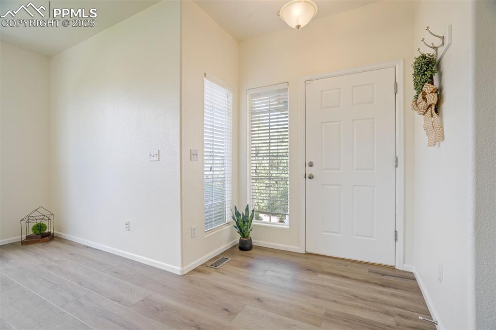 Image 4 of 38: Open and bright with high ceilings, new paint, new flooring!