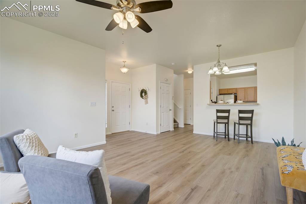 Image 6 of 38: Living Room opens to kitchen, dining space and counter seating