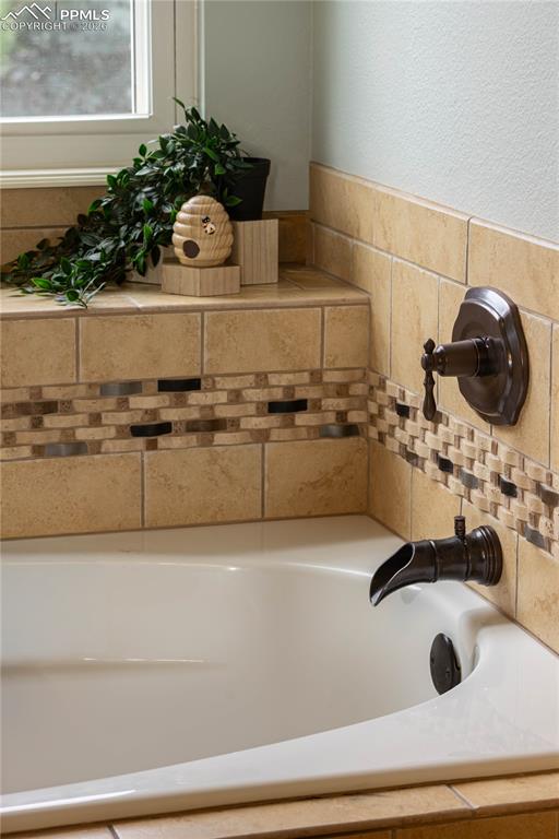 Image 36 of 48: Primary Soaking Tub with Shelf