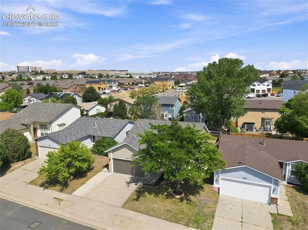 Image 26 of 30: Neighborhood setting featuring residential properties and mature landscapin