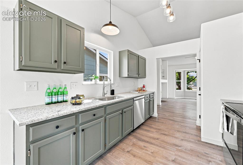 Image 9 of 30: Kitchen featuring wood-finish flooring, gray shaker-style cabinetry, light-
