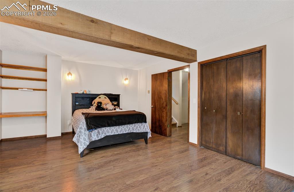 Image 27 of 45: Bedroom 3 on the lower level with a walk out to the covered dog run!